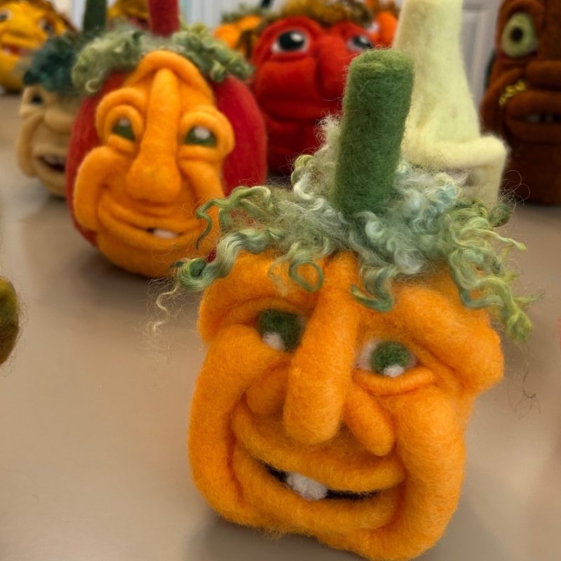 A crowd of needle-felted pumpkin characters