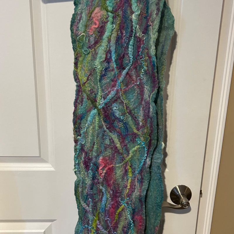 A long wet-felted scarf in teal and plum