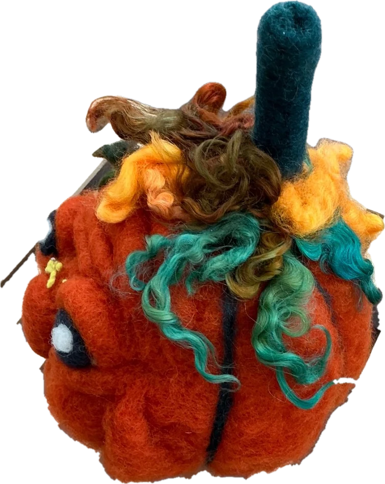 A needle-felted grumpy pumpkin seen from the side, showing its teal, orange, and brown wool curls
